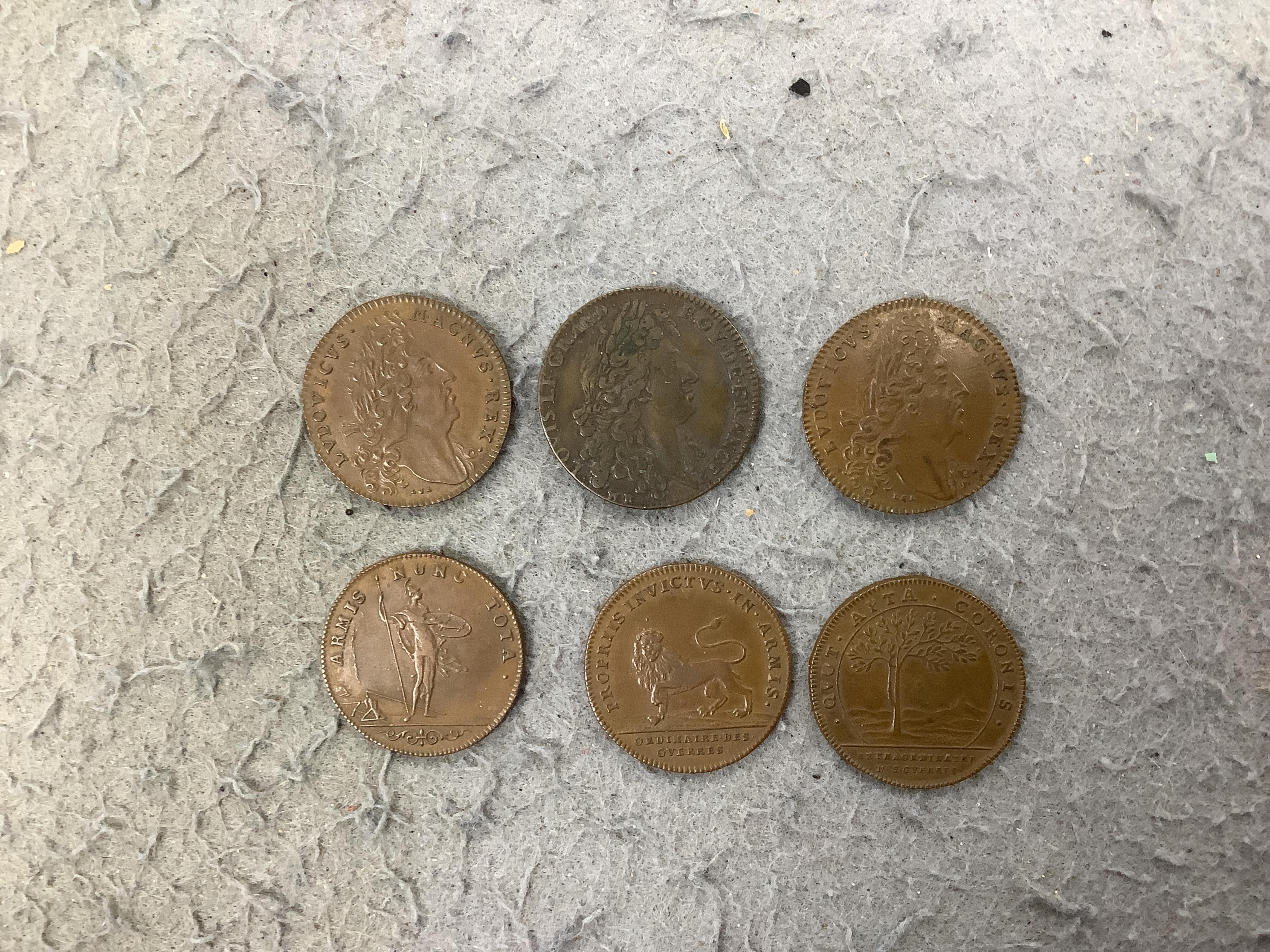 A large collection of halfpenny tokens and gaming tokens, 17th to early 20th century, in an album